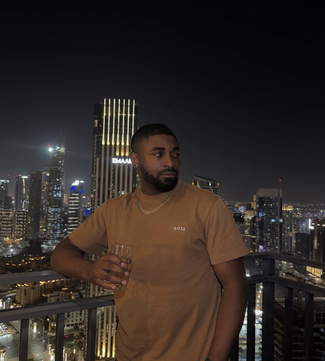 Portrait against a high-rise city skyline at night